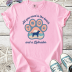 Pink graphic t-shirt featuring Labrador design and beach theme, perfect for dog lovers.