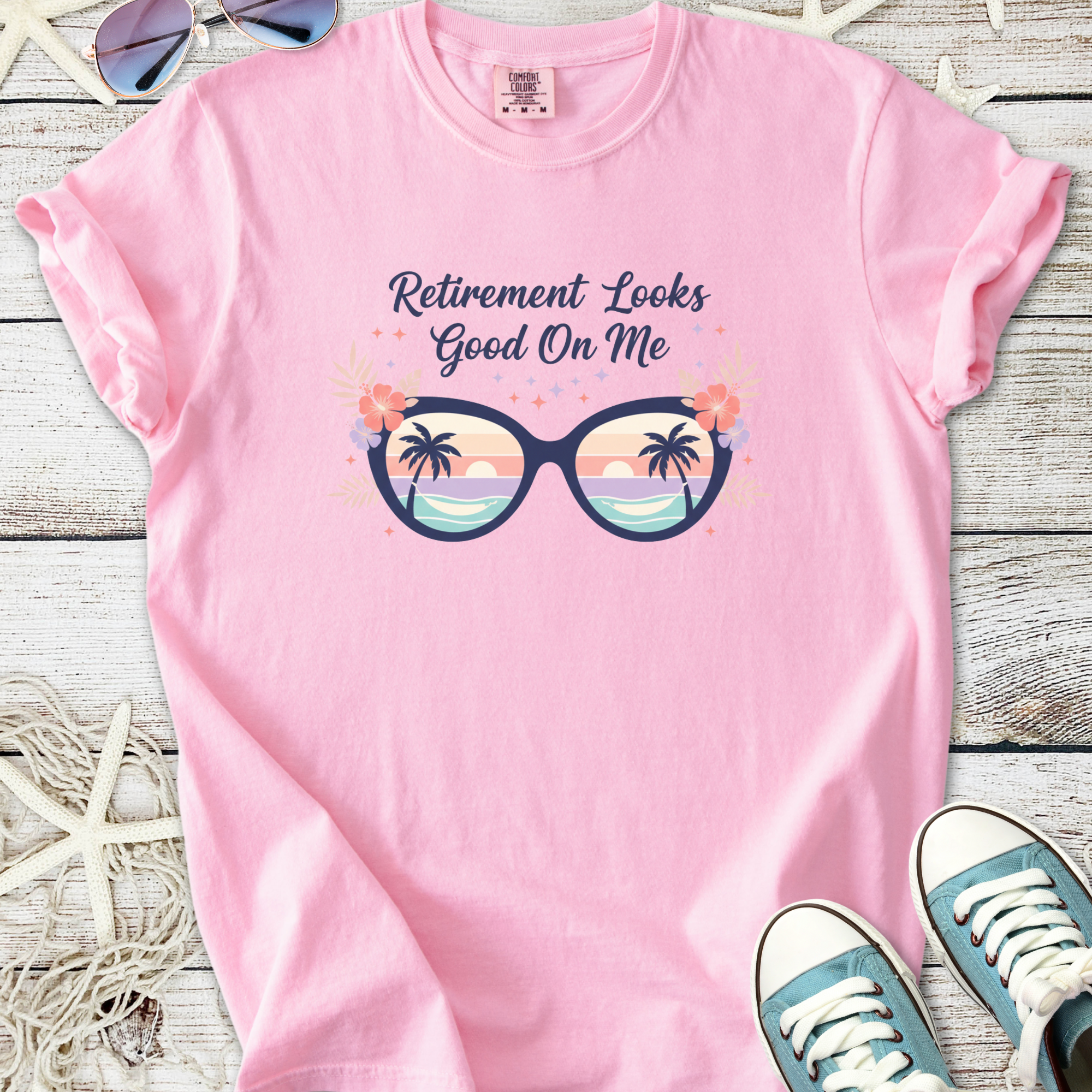Pink t-shirt with 'Retirement Looks Good On Me' graphic, featuring sunglasses and palm trees.