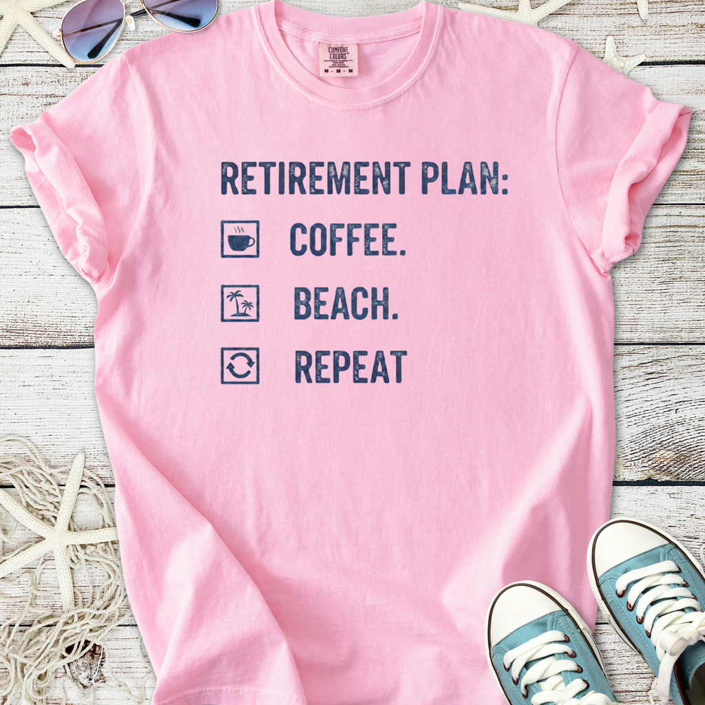Pink cotton t-shirt with 'Retirement Plan: Coffee, Beach, Repeat' graphic design.