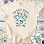 Light pink t-shirt with beach-themed dog paw print graphic and text 'All you need is the beach and a dog'.