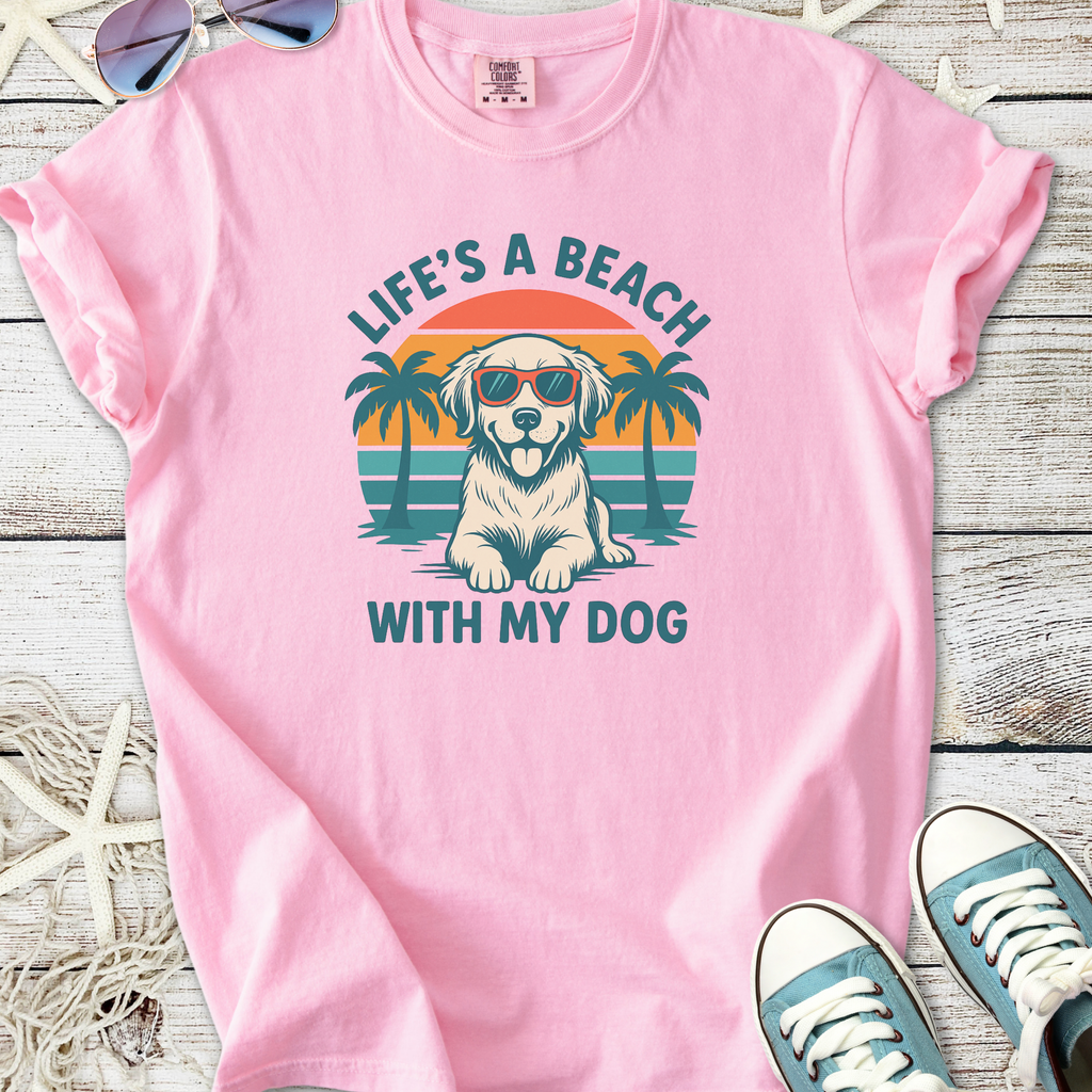 Pink graphic t-shirt featuring a dog in sunglasses and palm trees with the text 'Life's a Beach with My Dog'.
