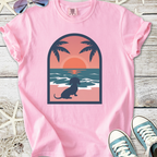 Pink graphic t-shirt with a sunset and dog design, perfect for casual summer wear.