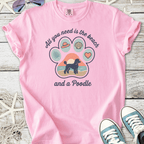 Pink t-shirt with beach-themed print featuring a poodle silhouette and summer icons