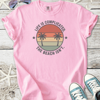 Pink cotton t-shirt with beach-themed graphic and palm trees, perfect for casual summer wear.