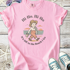 Pink cotton t-shirt featuring a beach-themed graphic and playful text for summer adventures.
