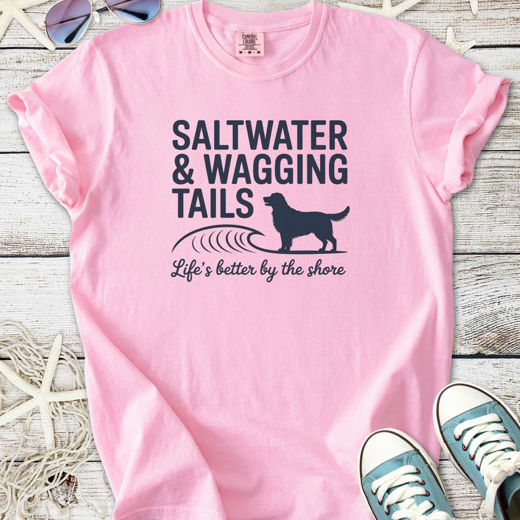 Pink t-shirt with 'Saltwater & Wagging Tails' design, perfect for beach lovers and dog owners.