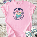 Pink cotton t-shirt with 'Retired: Too Salty to Be Sorry' graphic and tropical drink design.
