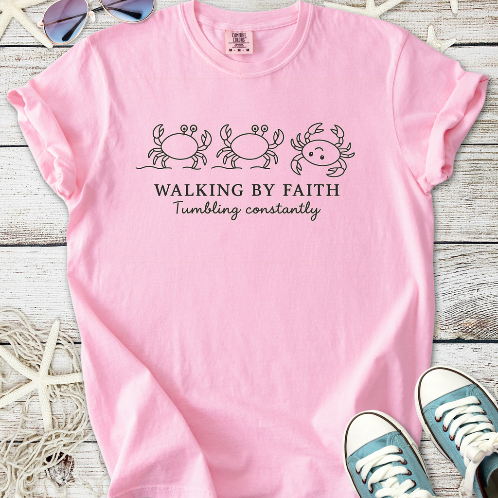 Pink graphic t-shirt featuring crabs and the phrase 'Walking by Faith' for a fun, casual style.