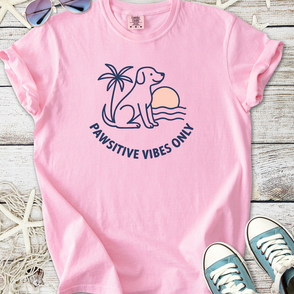 Pink cotton t-shirt featuring a cute dog and palm tree design with 'Pawsitive Vibes Only' slogan.