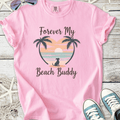 Pink graphic tee with 'Forever My Beach Buddy' print, featuring palm trees and sunset design.