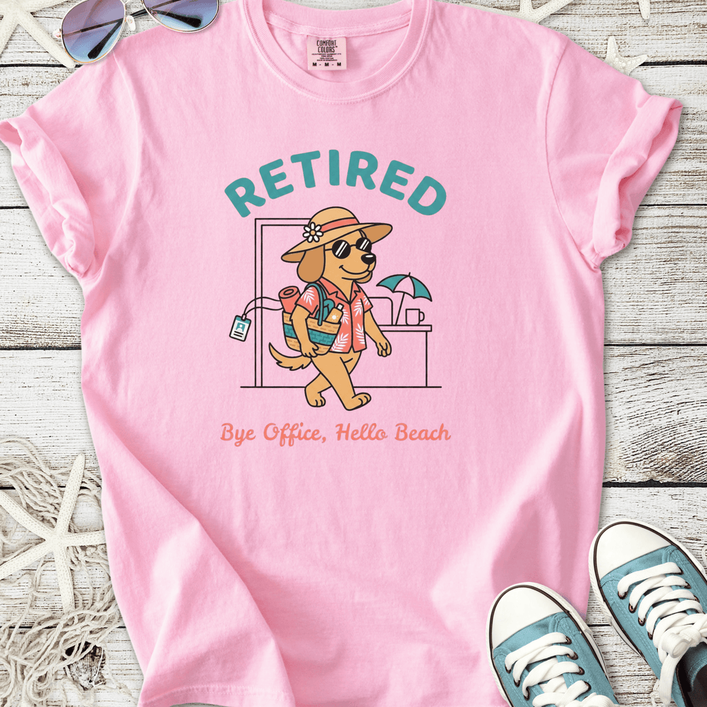 Pink t-shirt featuring a cartoon dog in vacation attire with 'Retired' slogan, perfect for beach lovers.