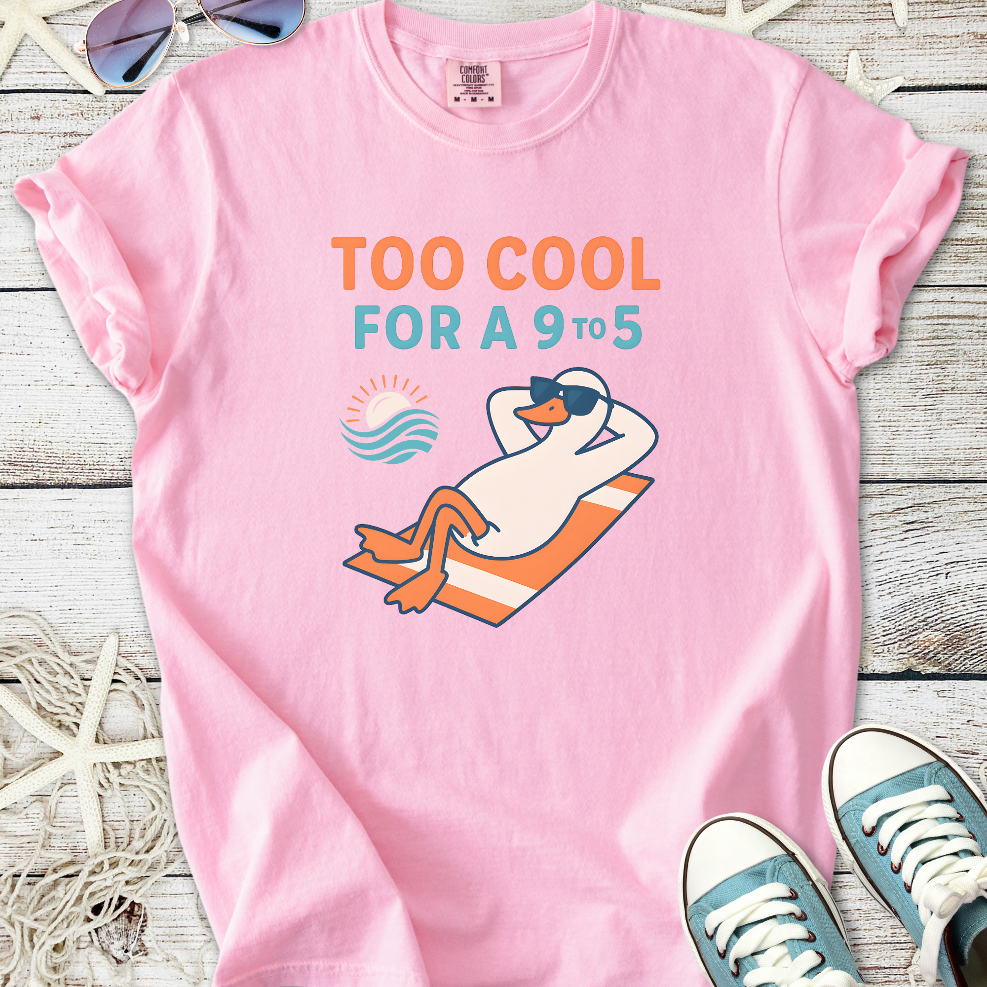 Pink graphic tee featuring a cool duck lounging with "Too Cool for a 9 to 5" text, perfect for casual wear.
