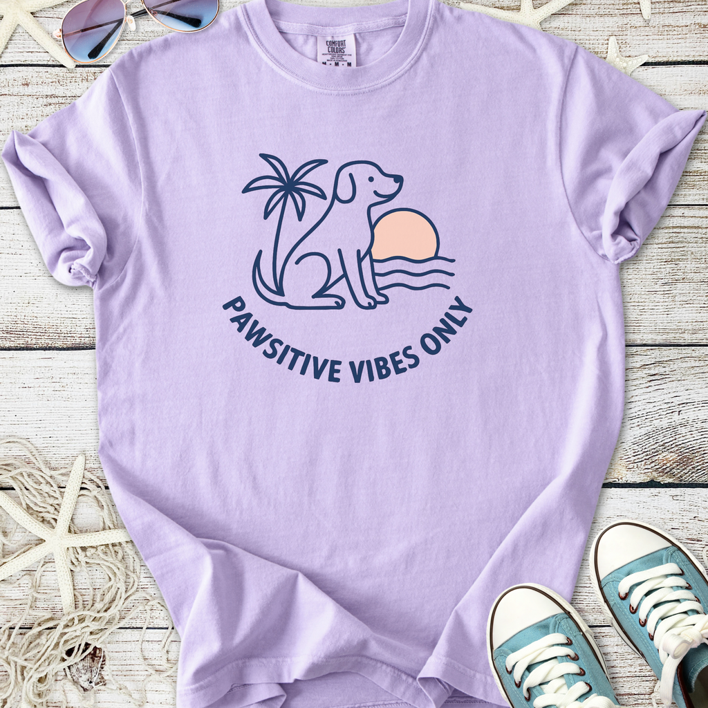 Light purple t-shirt featuring a dog silhouette, palm tree, and 'Pawsitive Vibes Only' design.