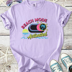 Lilac graphic t-shirt with 'Beach Mode Activated' print and palm tree design, perfect for summer outings.