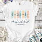 White t-shirt with 'Anchored in Faith' design and biblical symbols, perfect for faith-based casual wear.