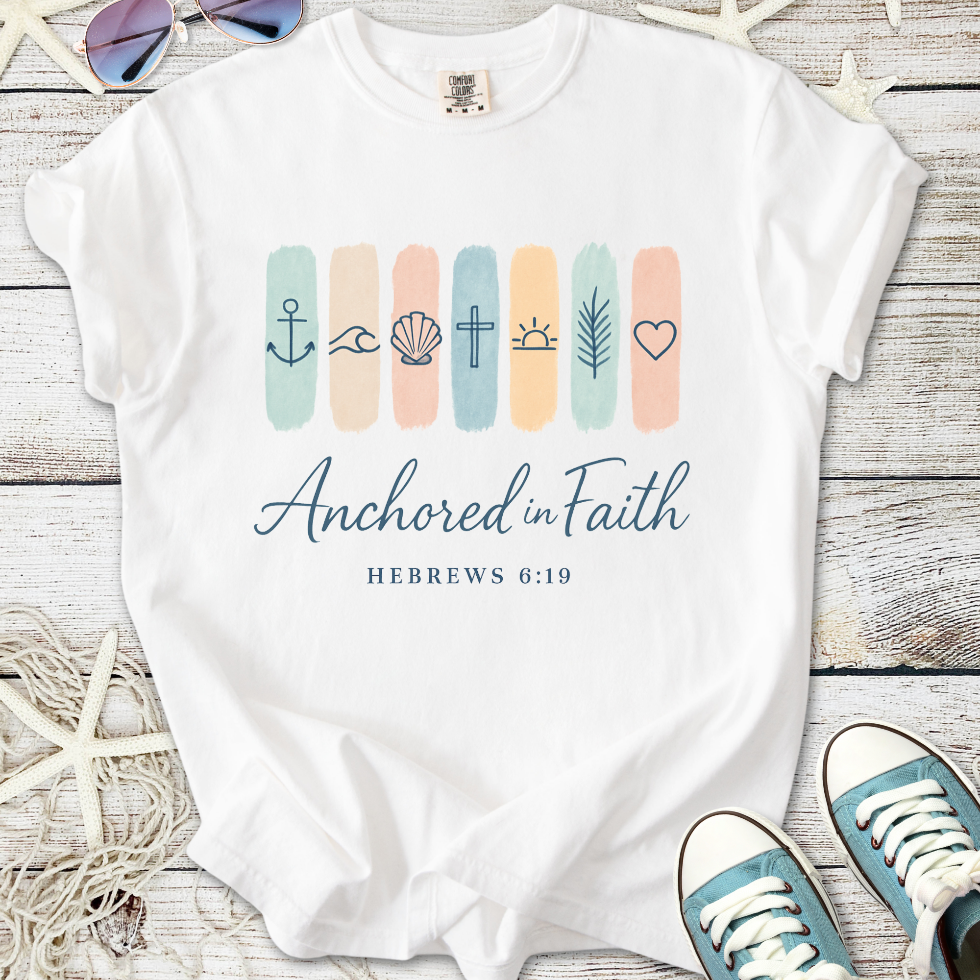 White t-shirt with 'Anchored in Faith' design and biblical symbols, perfect for faith-based casual wear.