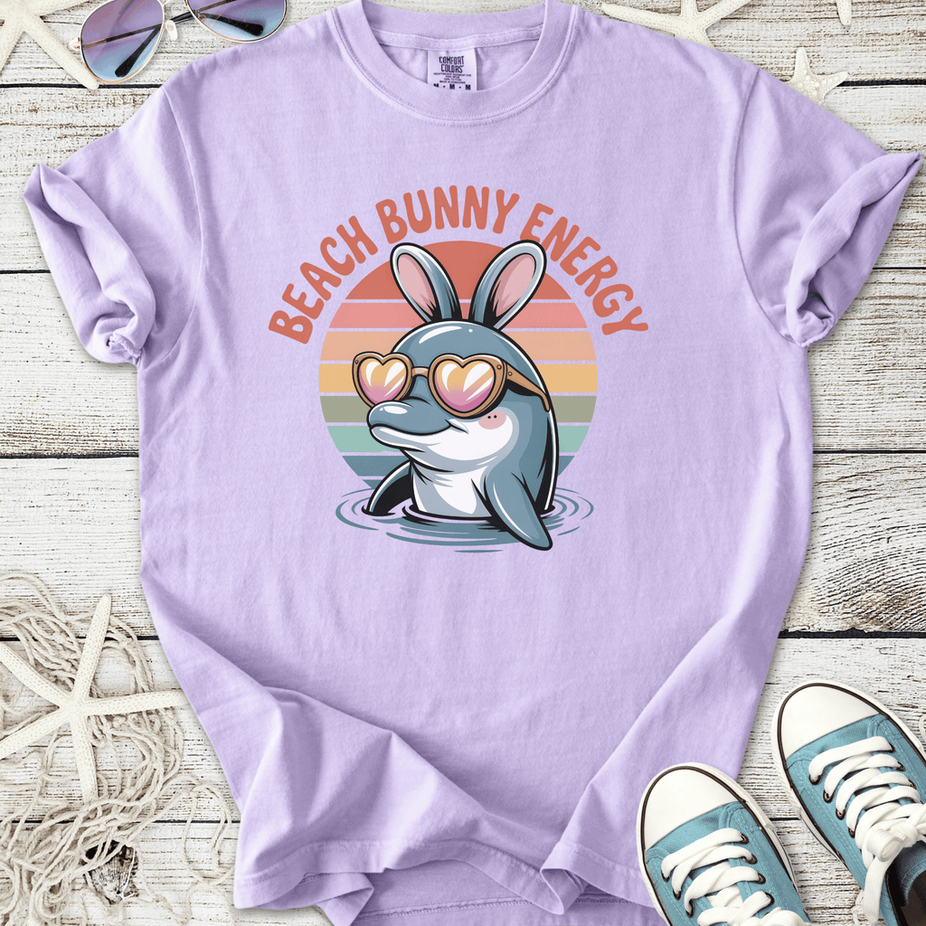Lilac unisex t-shirt featuring a dolphin in sunglasses with 'Beach Bunny Energy' graphic.
