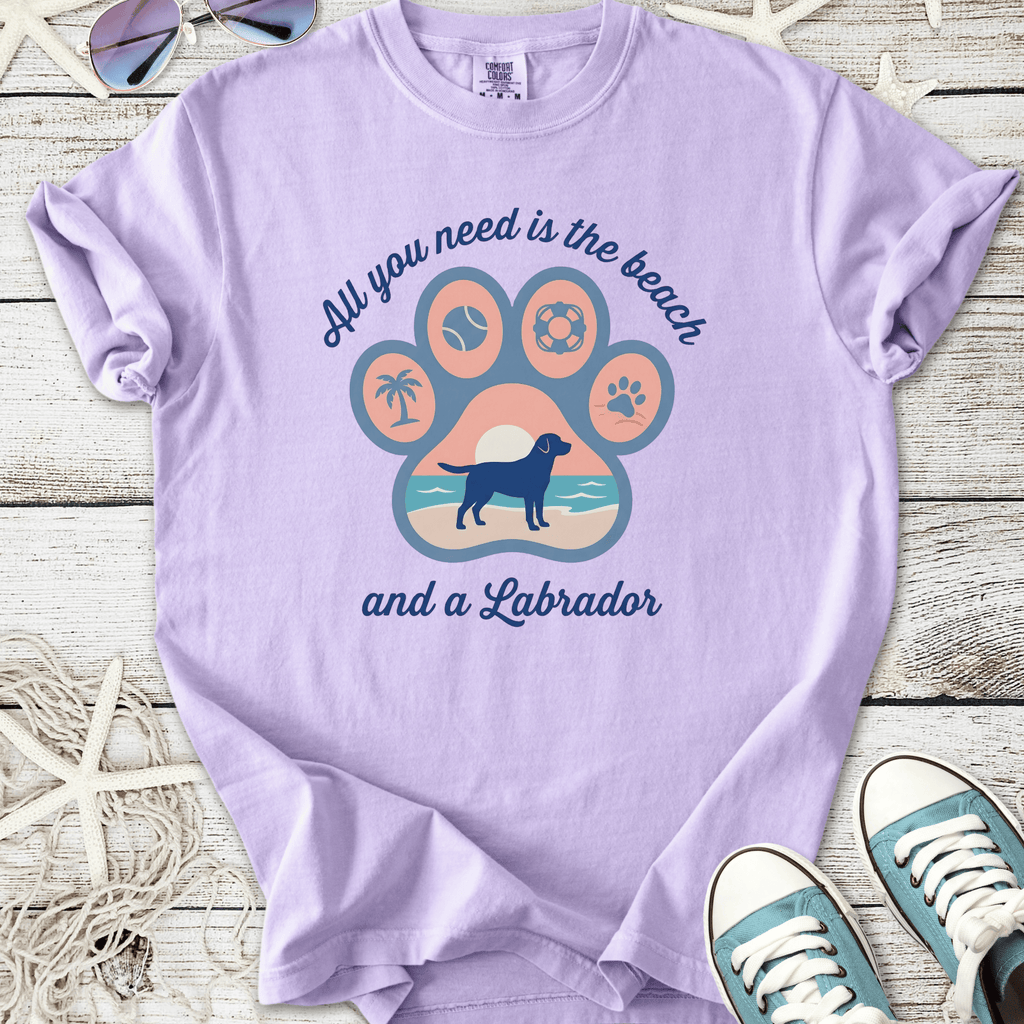 Purple t-shirt featuring Labrador design with beach theme, perfect for dog lovers.