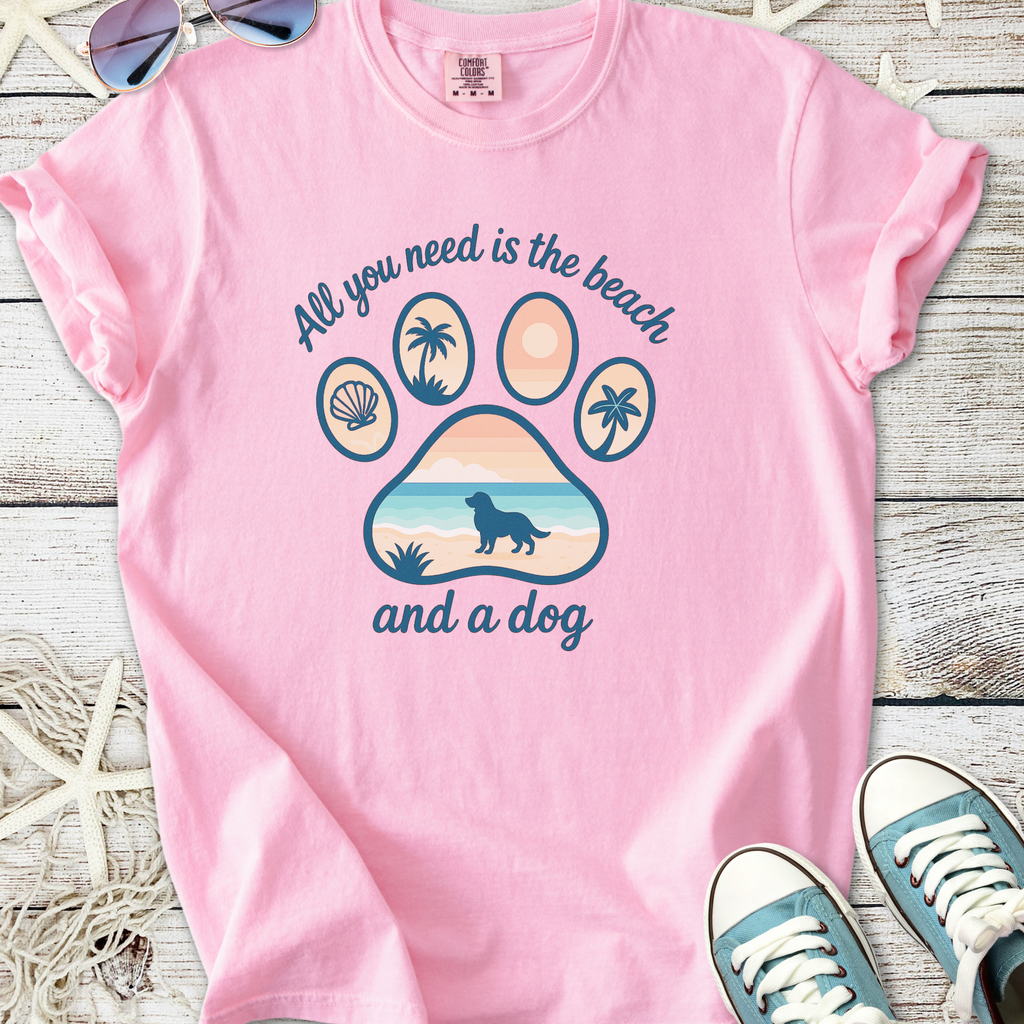 Pink graphic t-shirt with beach and dog print, perfect for dog lovers and beachgoers.