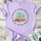 Lavender graphic tee with floral design and cross, featuring 'Grace Upon Grace' text, perfect for casual wear.
