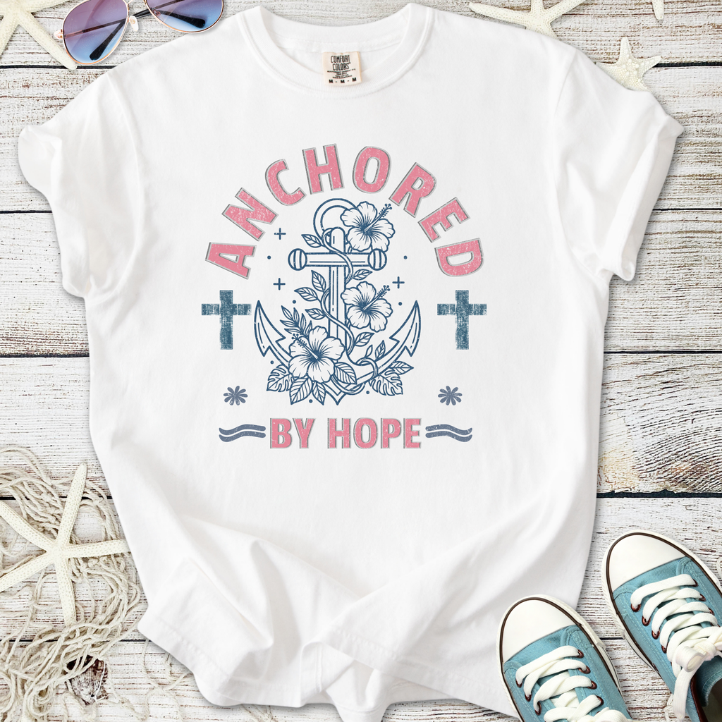 White t-shirt featuring an anchor and floral design with the phrase 'Anchored By Hope'.