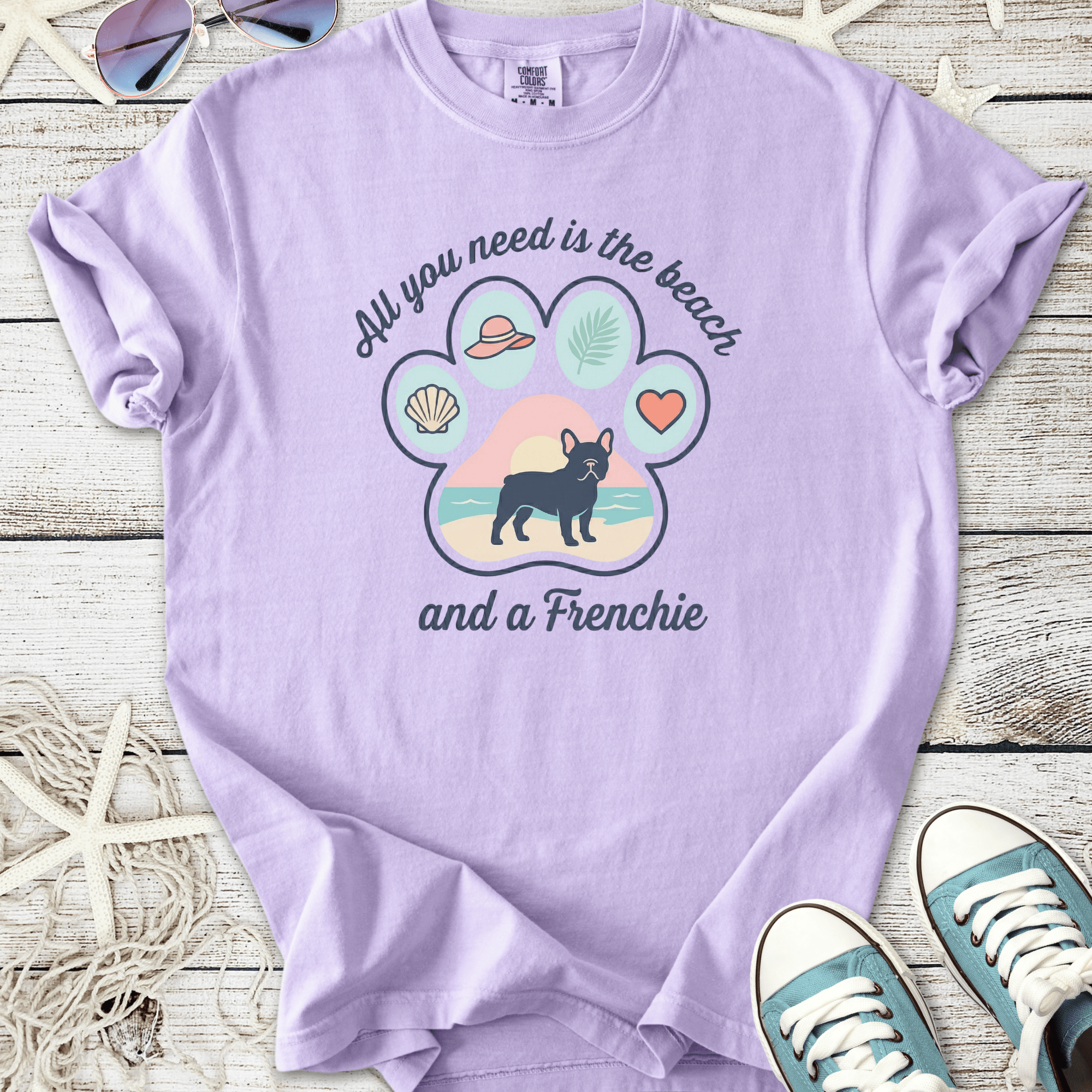 Lavender graphic tee featuring a French Bulldog, beach theme, and playful design elements.