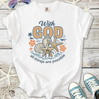 White t-shirt with beach-themed graphic, featuring text 'With God all things are possible' and marine elements.