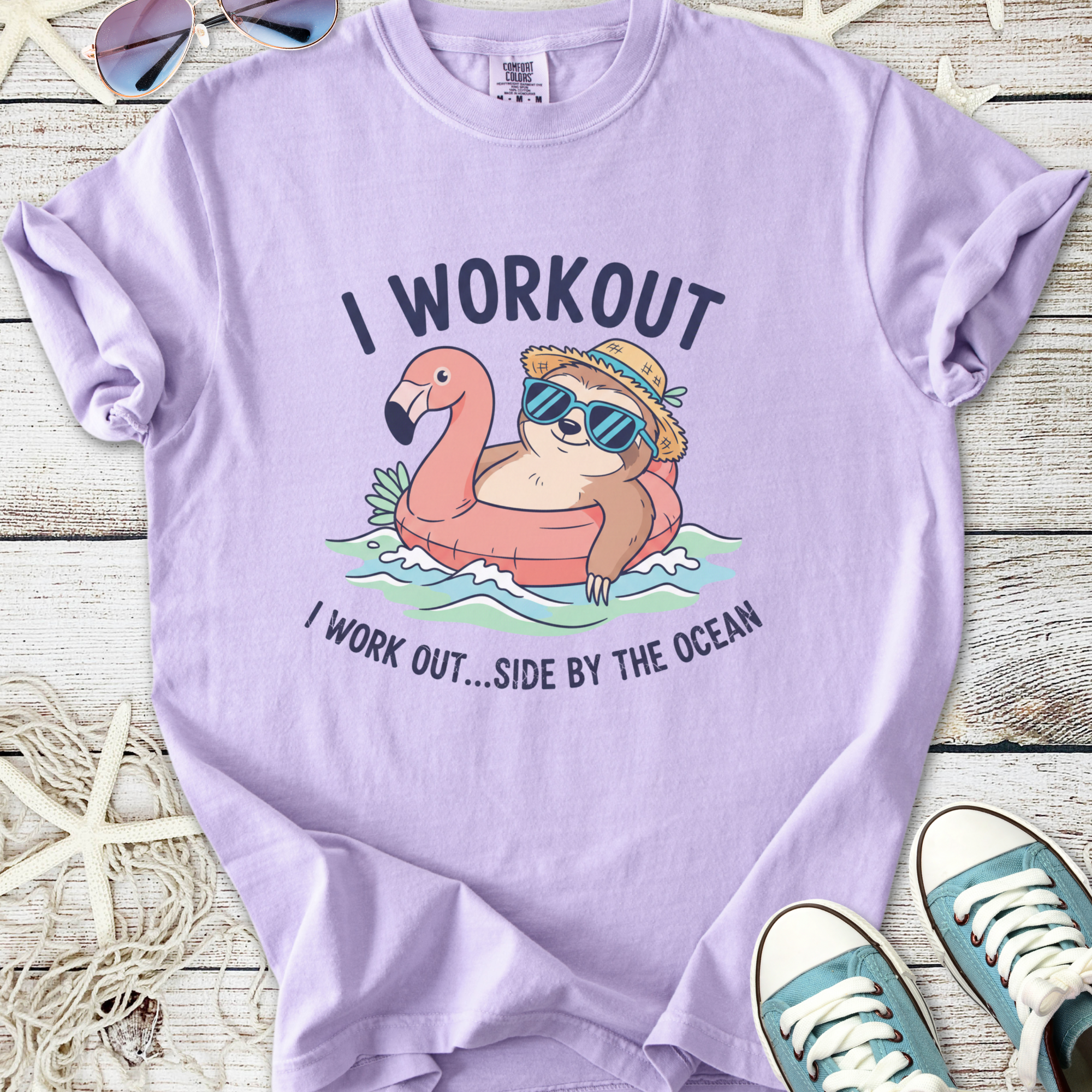 Light purple summer t-shirt featuring a sloth on a flamingo float with sunglasses and beach vibes.