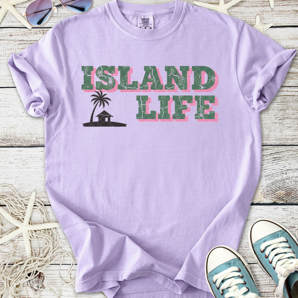 Lavender graphic T-shirt with 'Island Life' print, featuring palm tree design, perfect for casual wear.