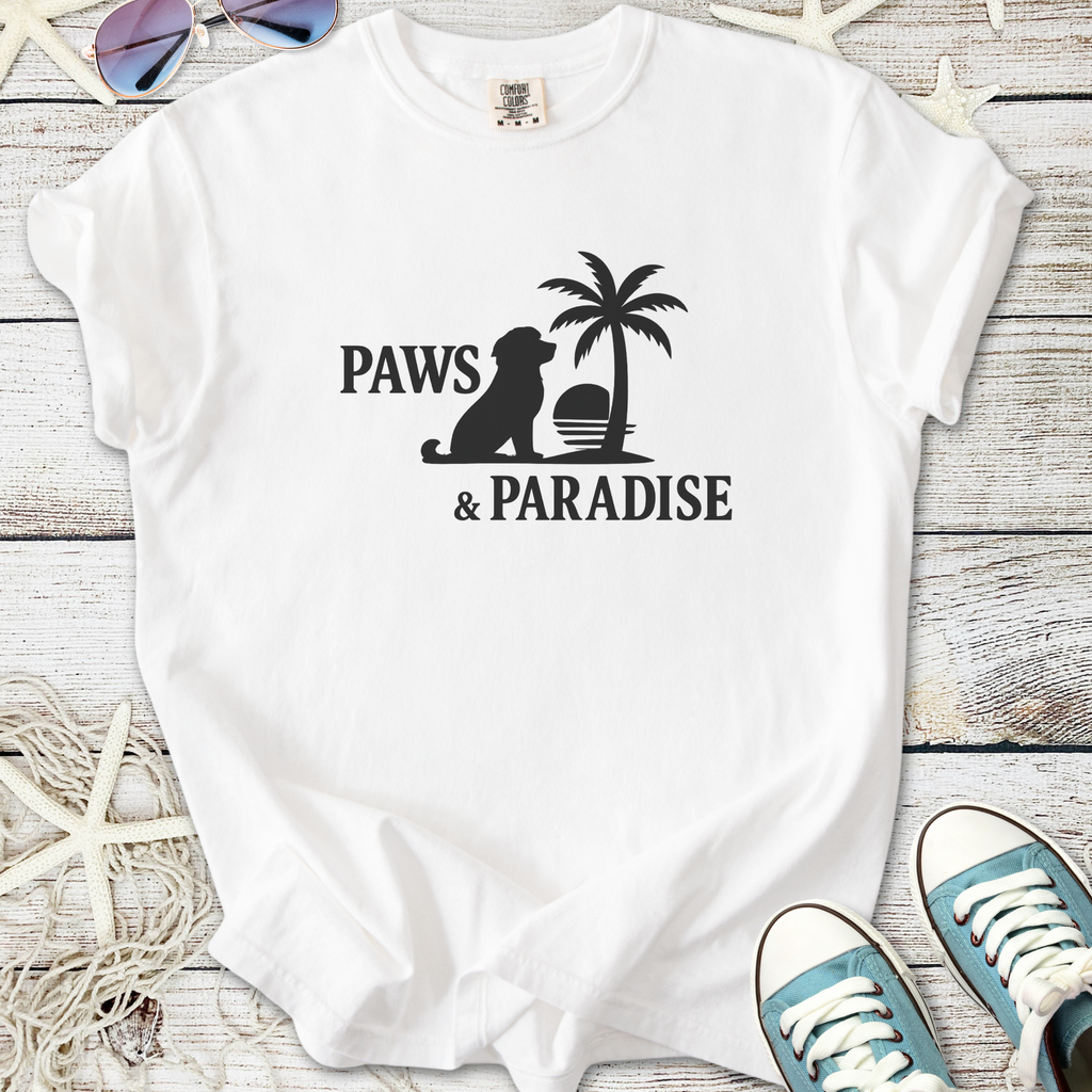 White cotton t-shirt featuring 'Paws & Paradise' design with a dog silhouette and palm tree.