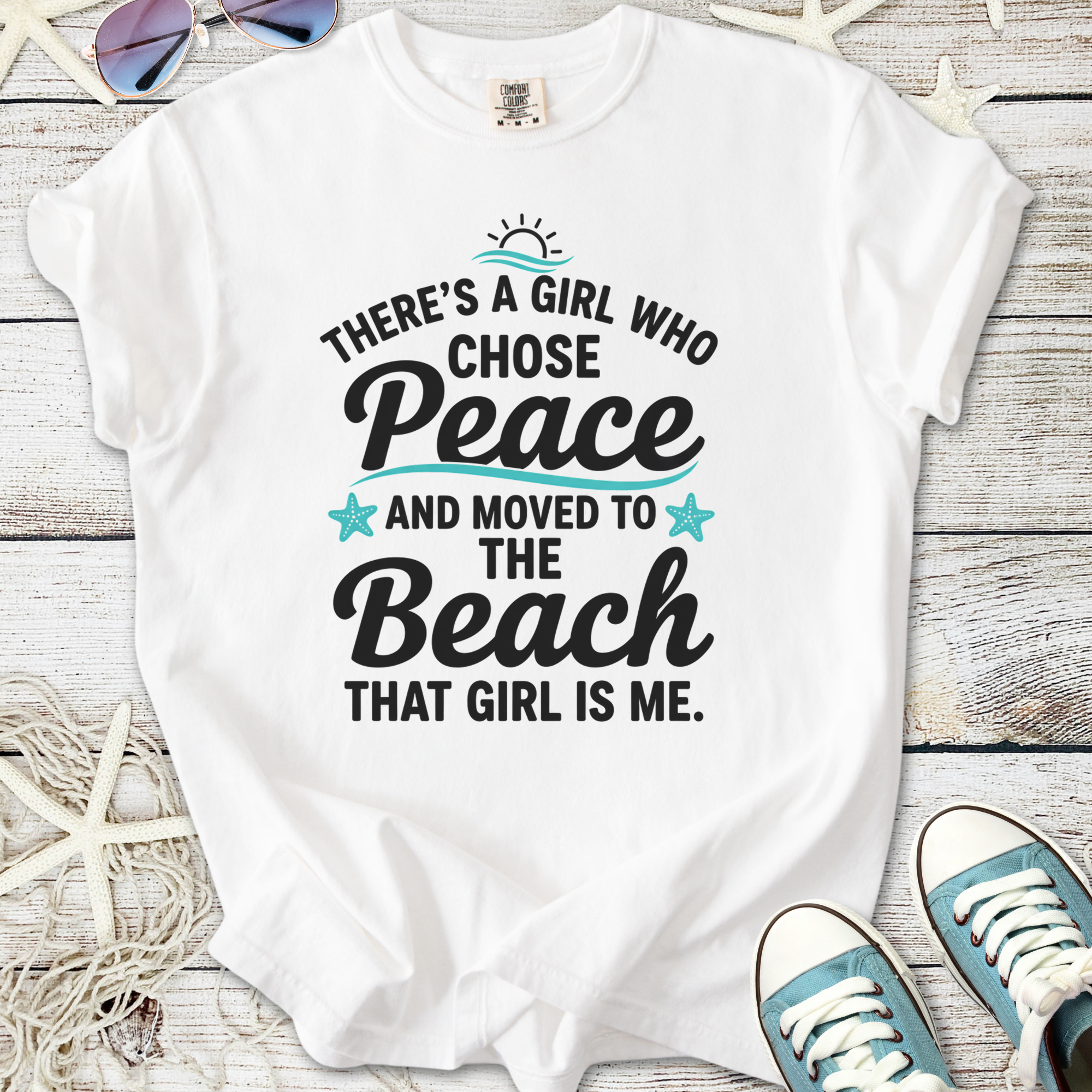 White women's t-shirt with beach-themed graphic: "There's a girl who chose peace and moved to the beach".