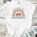 White t-shirt with 'Retirement Plan: Sunsets & Palm Trees' graphic, perfect for relaxed summer vibes.