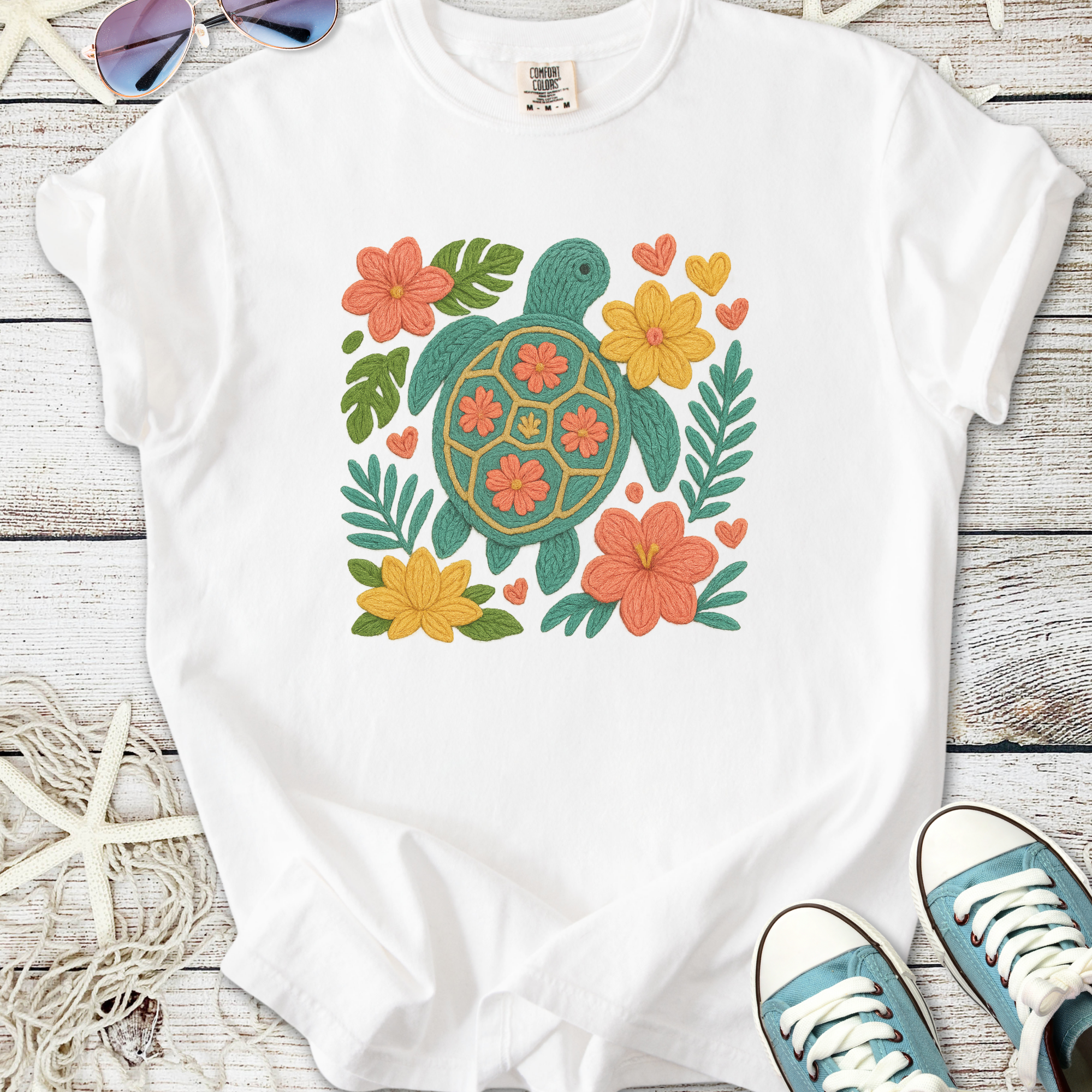 White t-shirt featuring a colorful turtle and floral design, perfect for casual summer wear.