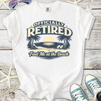 White t-shirt with 'Officially Retired' beach graphic and palm trees, perfect for beach lovers.