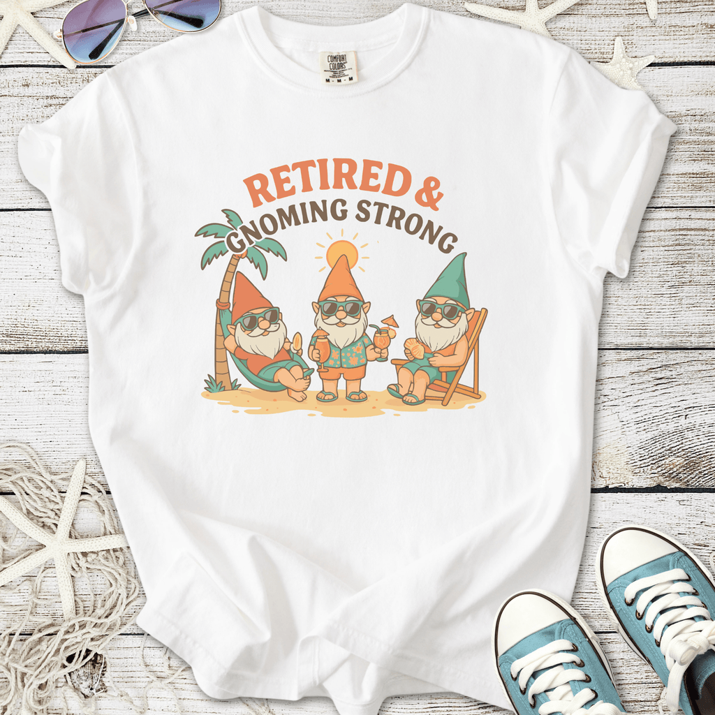 White t-shirt featuring playful gnomes with sunglasses, text 'Retired & Gnoming Strong', perfect for leisure.