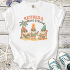 White t-shirt featuring playful gnomes with sunglasses, text 'Retired & Gnoming Strong', perfect for leisure.