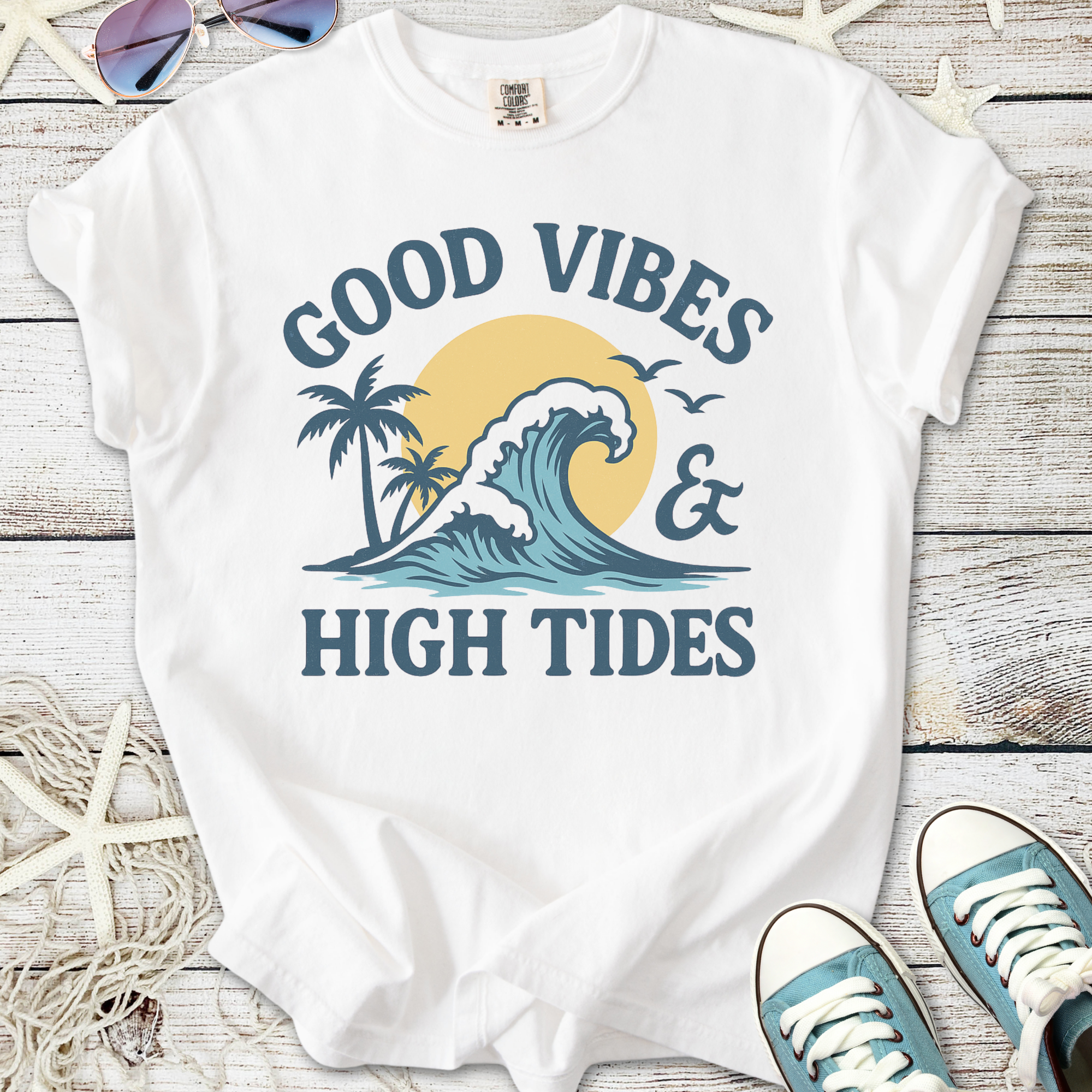 White t-shirt with 'Good Vibes & High Tides' graphic featuring a wave and palm trees.