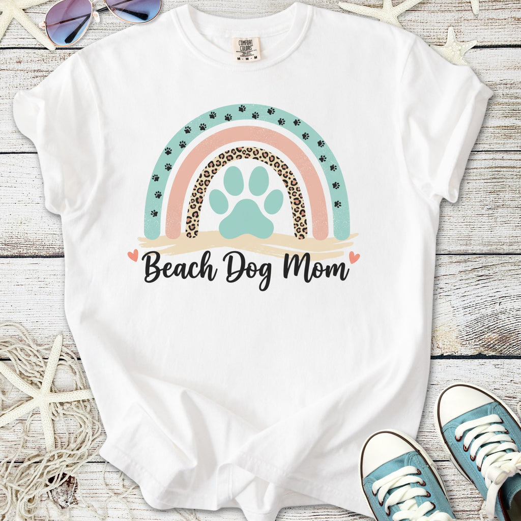 White t-shirt with colorful 'Beach Dog Mom' graphic and paw print design, perfect for dog lovers.