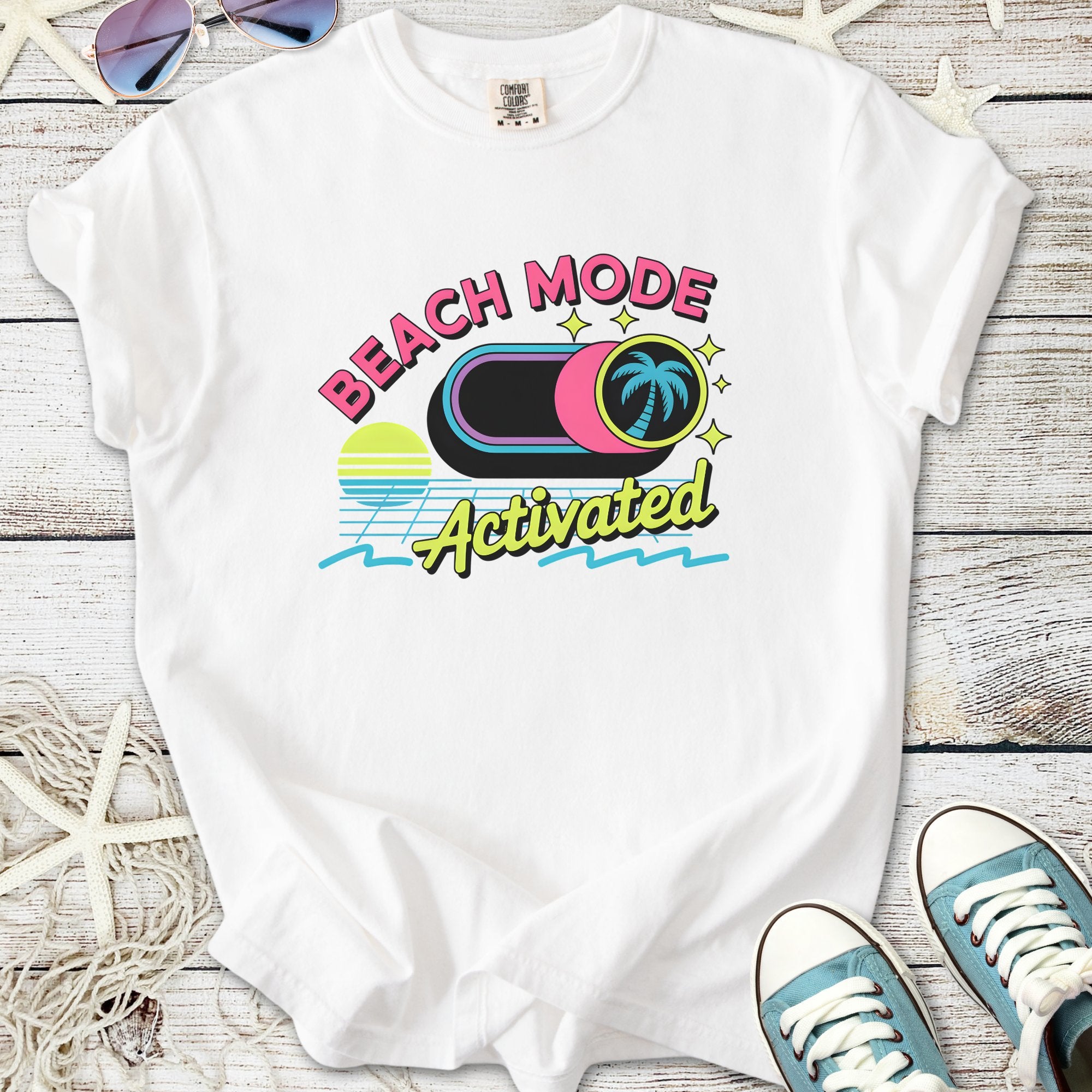 White beach-themed t-shirt with 'Beach Mode Activated' graphic design, perfect for summer outings.