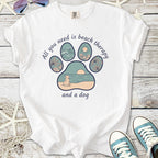 White t-shirt with beach therapy graphic featuring a dog, waves, and sun, perfect for pet lovers.