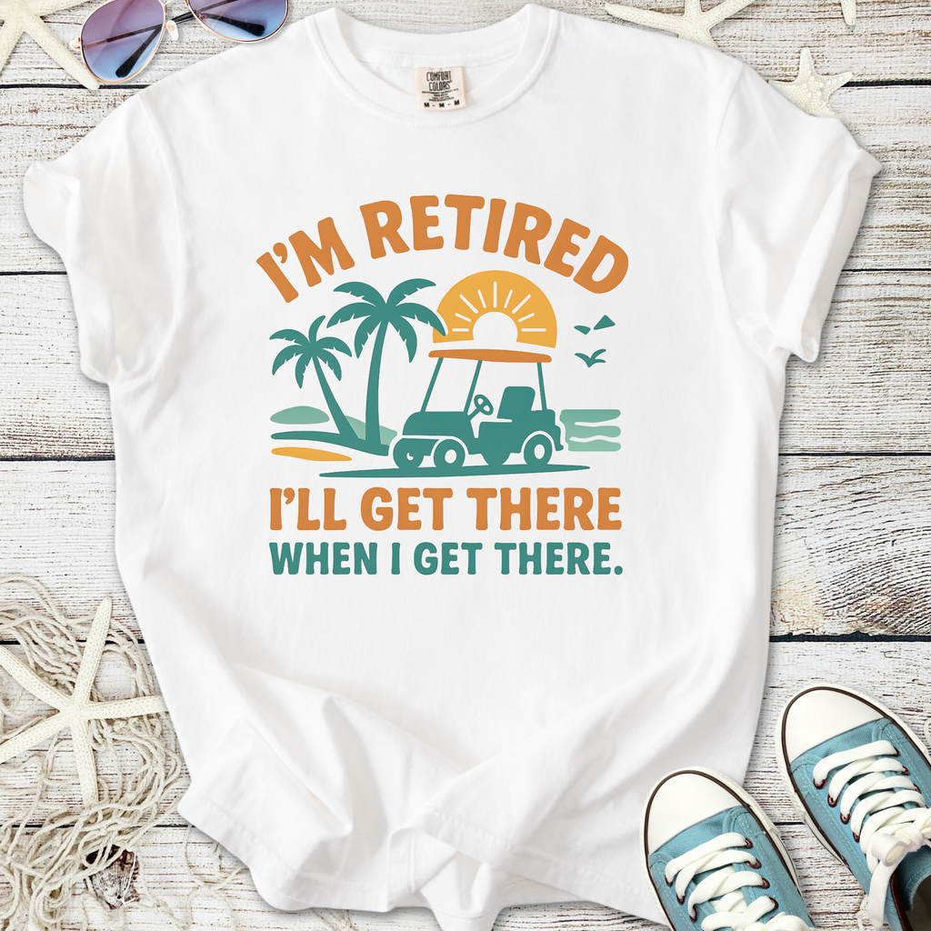 White t-shirt with 'I'm Retired, I'll Get There When I Get There' print featuring a golf cart and palm trees.