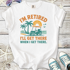 White t-shirt with 'I'm Retired, I'll Get There When I Get There' print featuring a golf cart and palm trees.