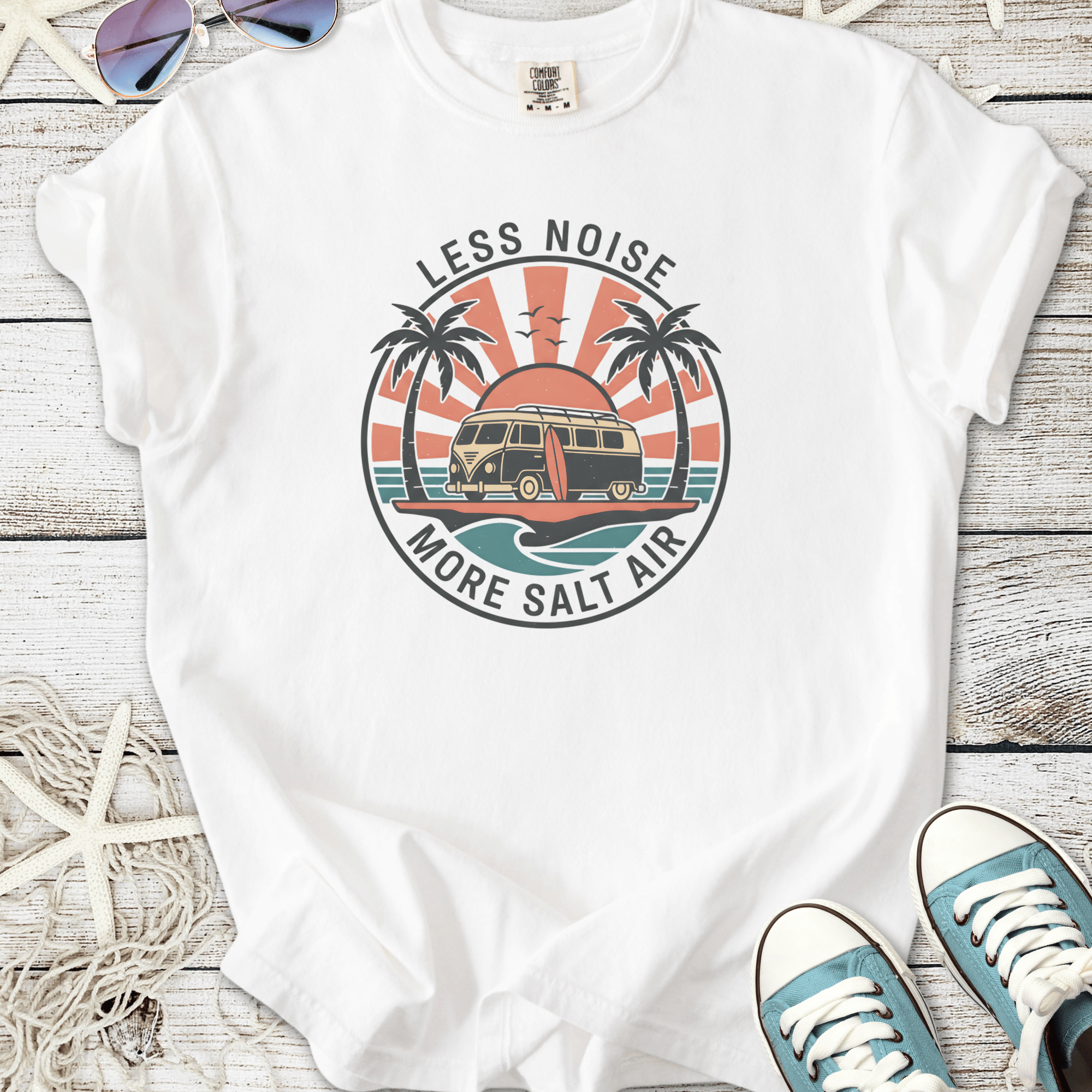 White t-shirt with 'Less Noise More Salt Air' graphic featuring a van and palm trees.