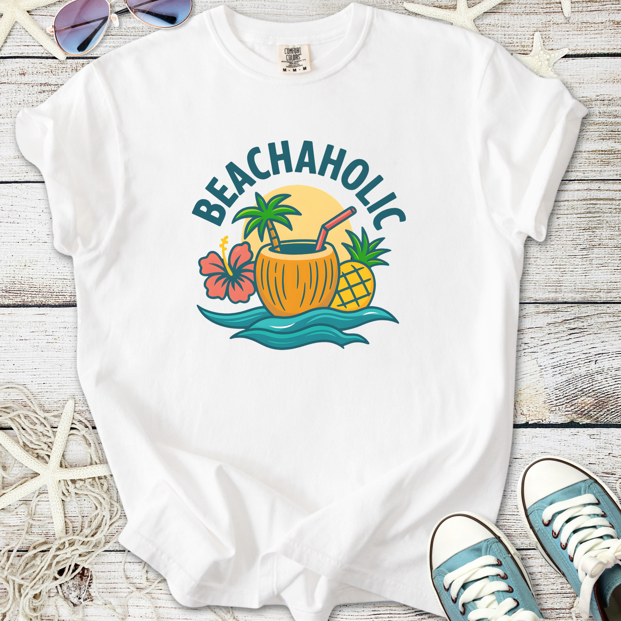 White cotton t-shirt featuring 'Beachaholic' graphic with tropical design, perfect for summer wear.
