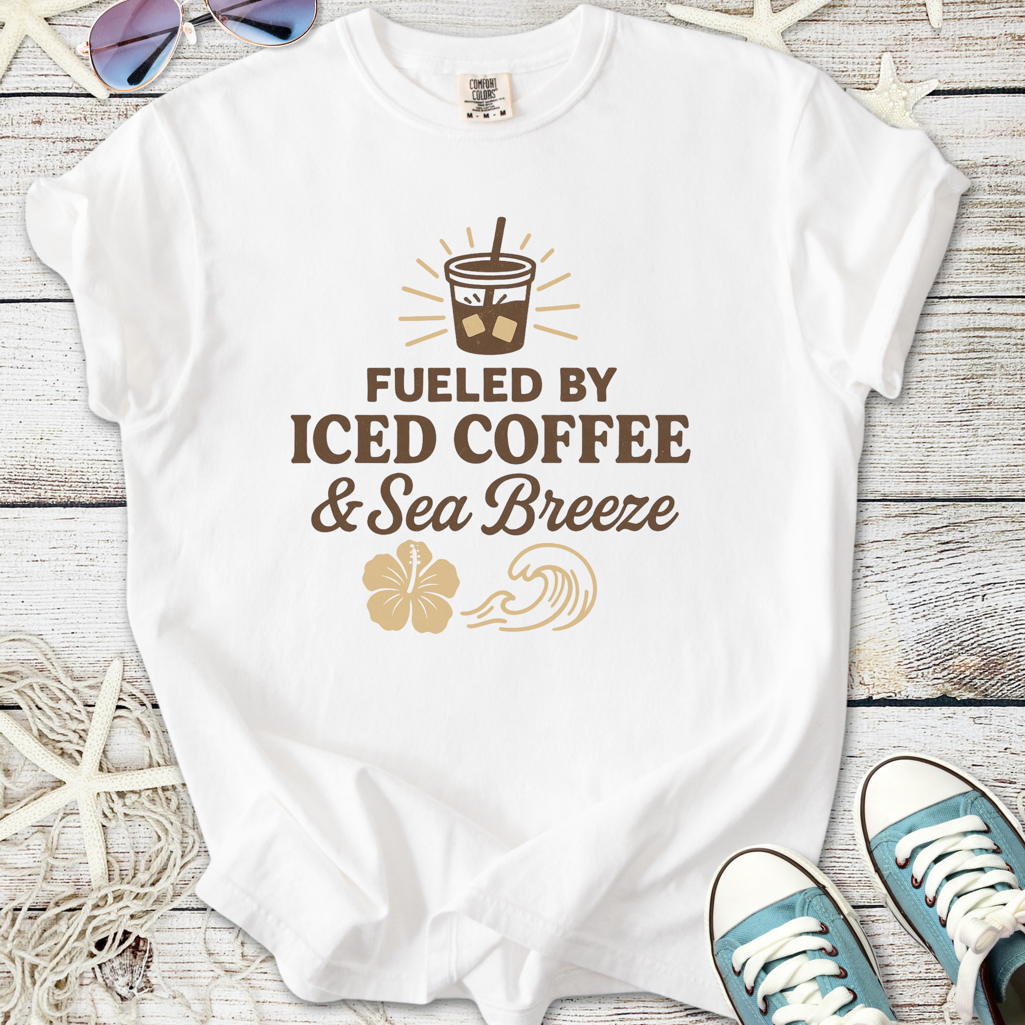 White t-shirt with 'Fueled by Iced Coffee & Sea Breeze' graphic, perfect for coffee lovers.