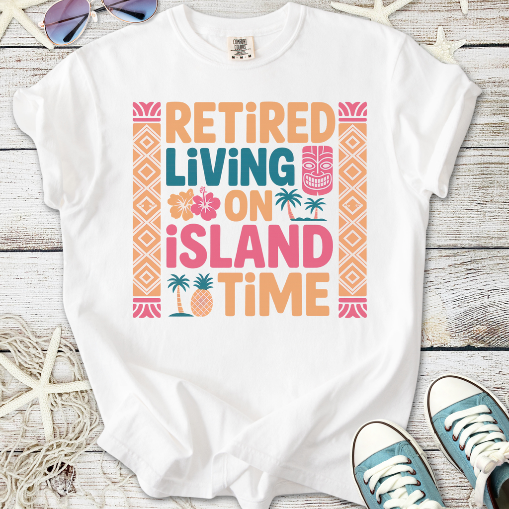 White graphic t-shirt featuring 'Retired Living on Island Time' design with tropical elements.