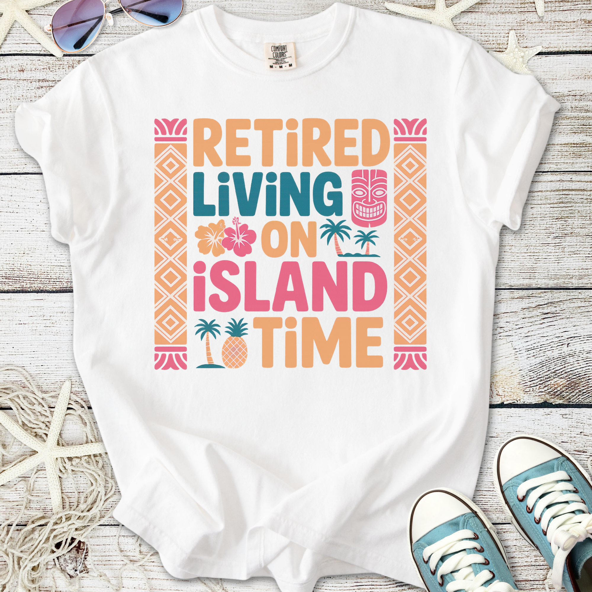 White graphic t-shirt featuring 'Retired Living on Island Time' design with tropical elements.
