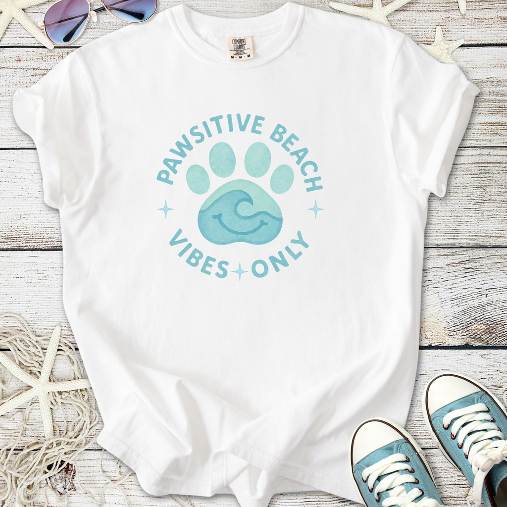 White t-shirt with 'Pawsitive Beach Vibes Only' graphic, featuring a blue paw and wave design.