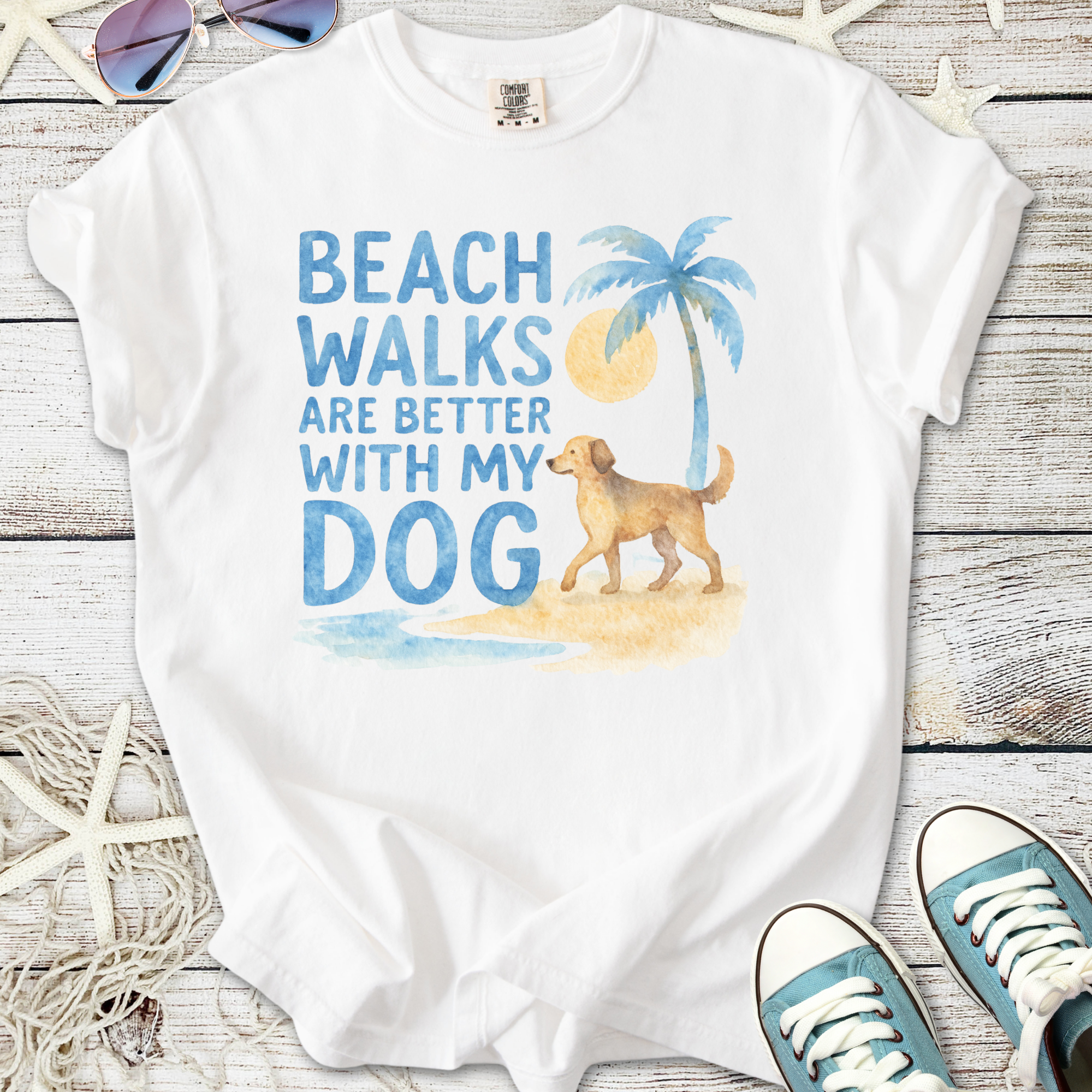 White t-shirt with 'Beach walks are better with my dog' graphic, featuring a golden retriever and palm tree.