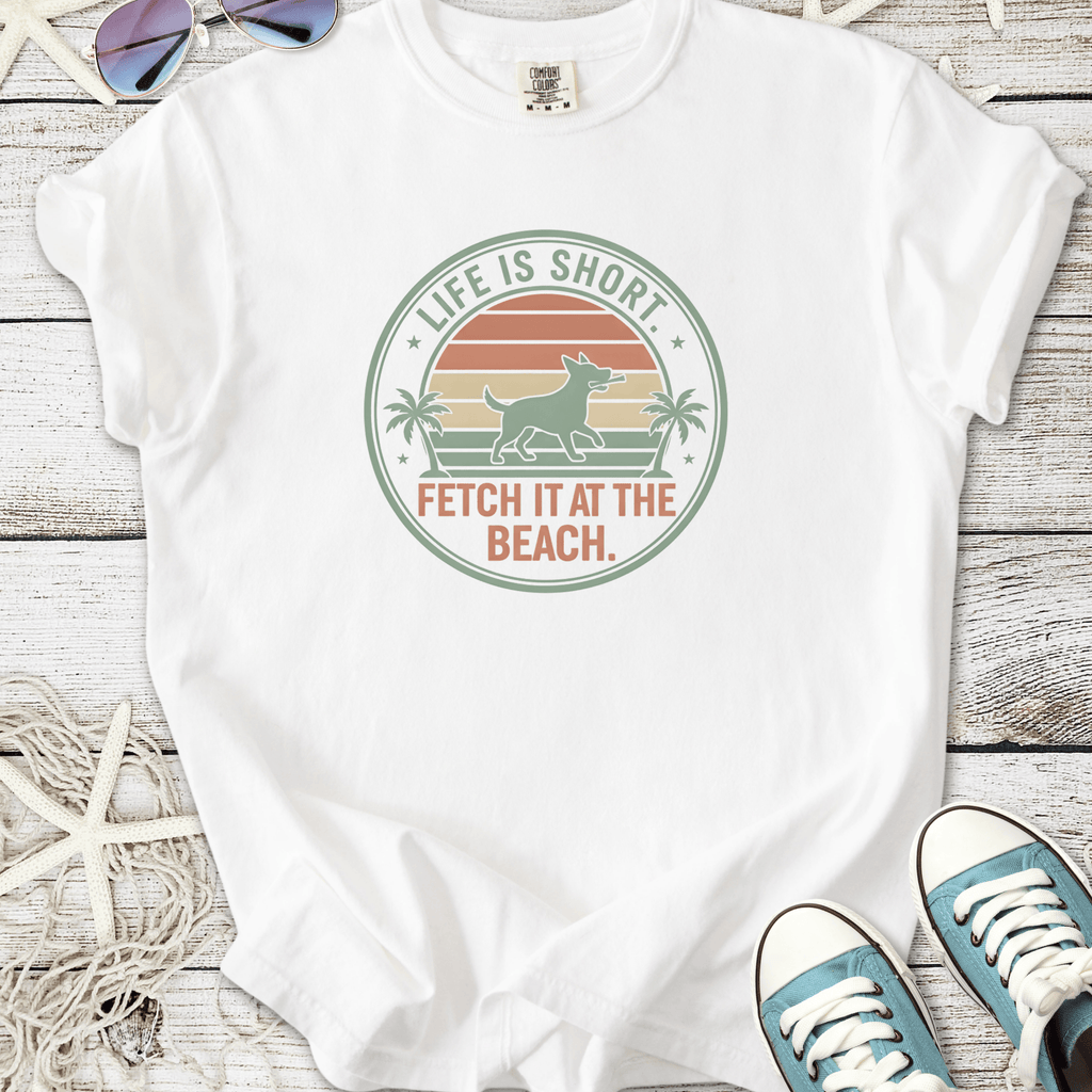White t-shirt with 'Life is Short, Fetch it at the Beach' graphic, featuring a dog and palm trees.